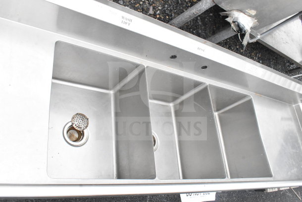 Commercial 3 bay stainless steel sink with dual drain boards, labeled "Wash," "Rinse," "Sanitize." No legs included.