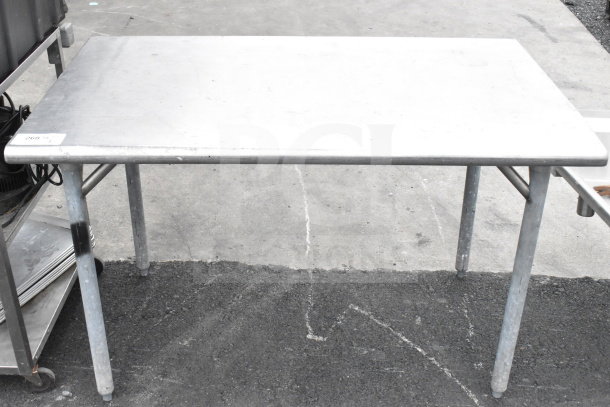 Stainless steel commercial table with sturdy legs, visible wear, and number tag "268" on the corner. Ideal for industrial use.