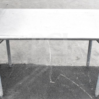 Stainless steel commercial table with sturdy legs, visible wear, and number tag "268" on the corner. Ideal for industrial use.