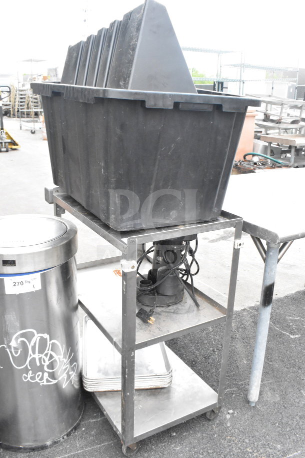 3-Tier Chrome Finish Cart with black storage bins and power cords on wheels. Signs of normal wear, suitable for storage or transport.