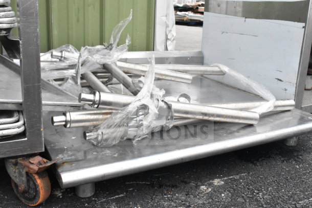 Commercial table with detachable legs, stainless steel, lightly used, on a platform with plastic wrapping visible.