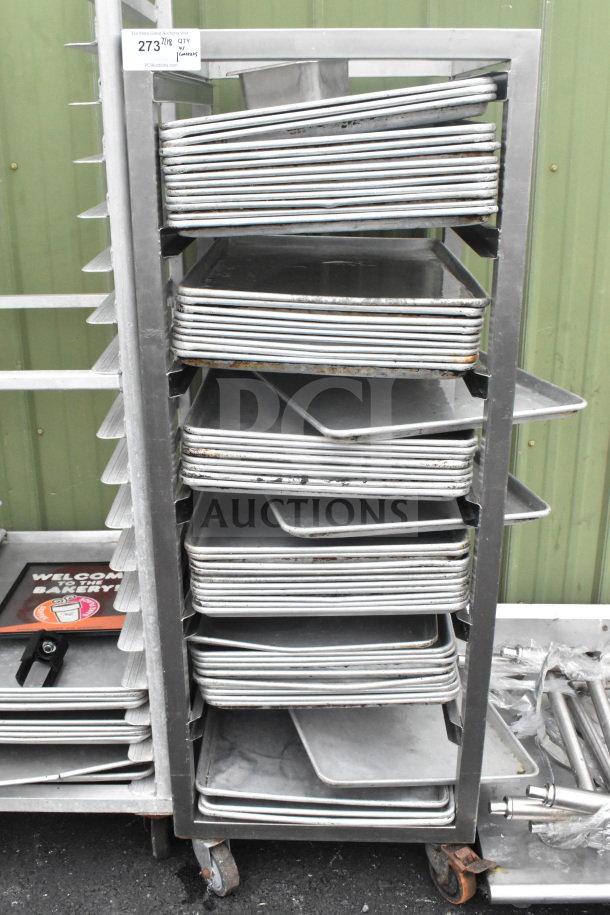 Commercial pan transport rack on casters with 50 baking pans. Includes metal construction and tag indicating item number 273.