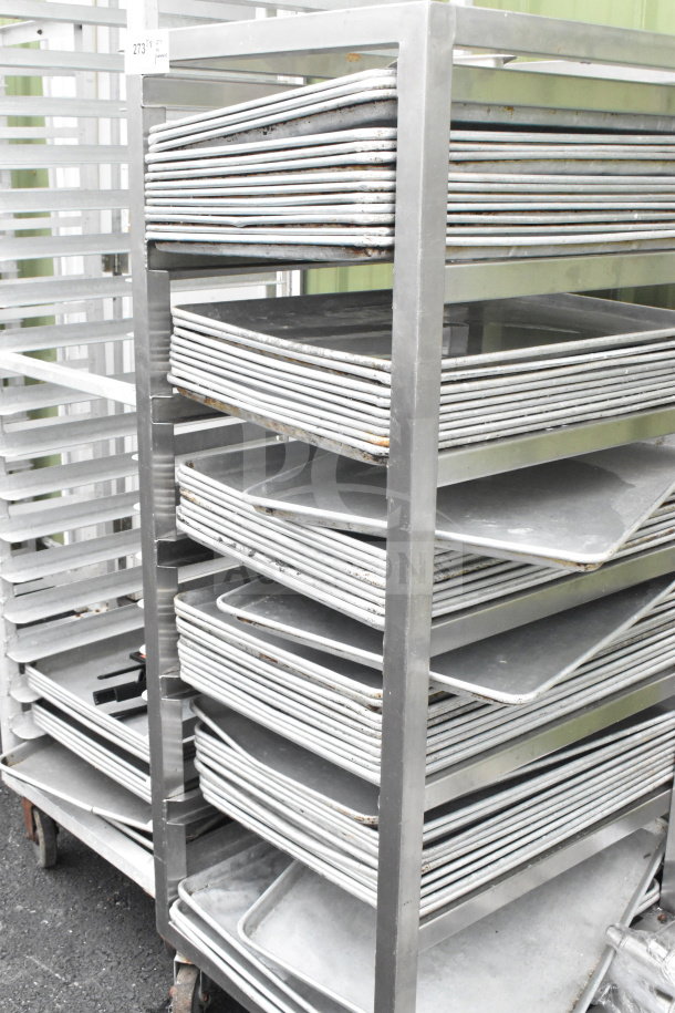 Commercial pan transport rack with 50 baking pans on casters, includes visible wear, metal construction, and mobility features.