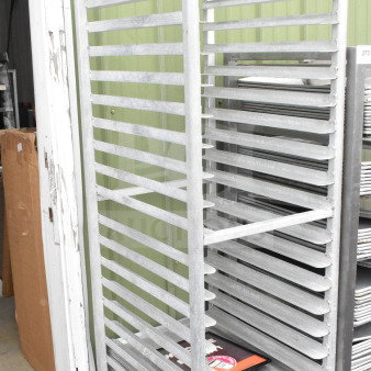 Commercial pan transport rack with 10 baking pans, on commercial casters, sturdy metal construction, good condition.