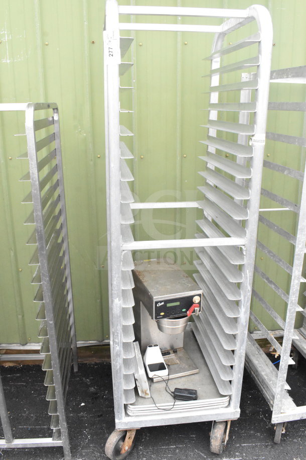 Commercial pan transport rack on casters with Curtis Coffee Machine, metal construction, visible wear.