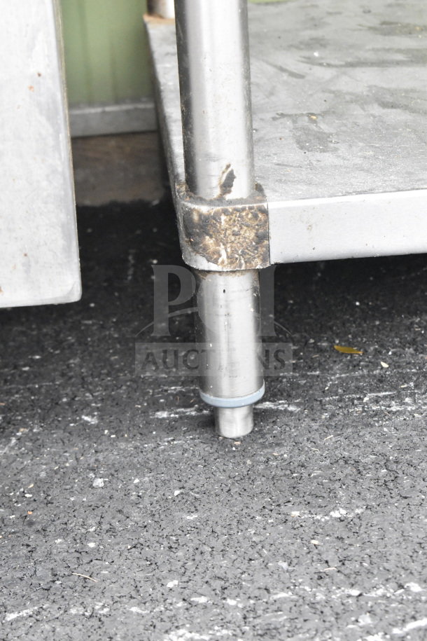 Commercial table leg and under shelf; stainless steel, shows moderate wear. Includes commercial can opener mount.