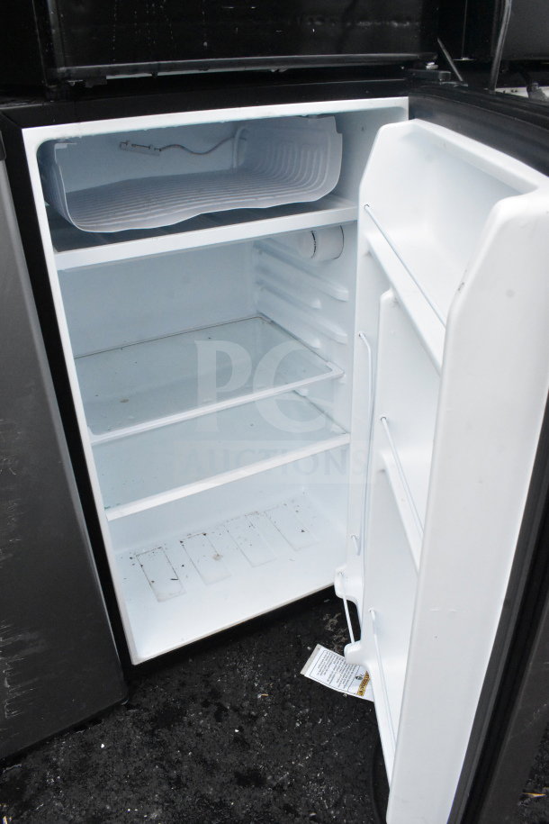 Four mini coolers including Galanz, Whirlpool, Hisense, Haier in used condition, open fridge view showing interior shelves. 115 volts, 1 phase.