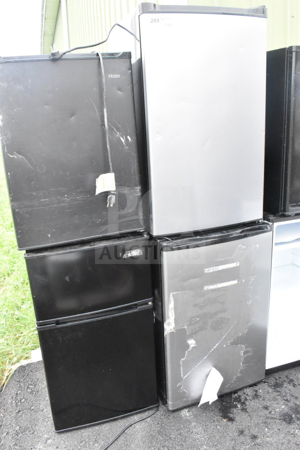 Four mini coolers, brands include Hisense, Arctic King, and Haier. Black and silver, 115 volts, for auction. Visible wear.
