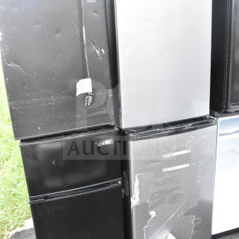 Four mini coolers, brands include Hisense, Arctic King, and Haier. Black and silver, 115 volts, for auction. Visible wear.