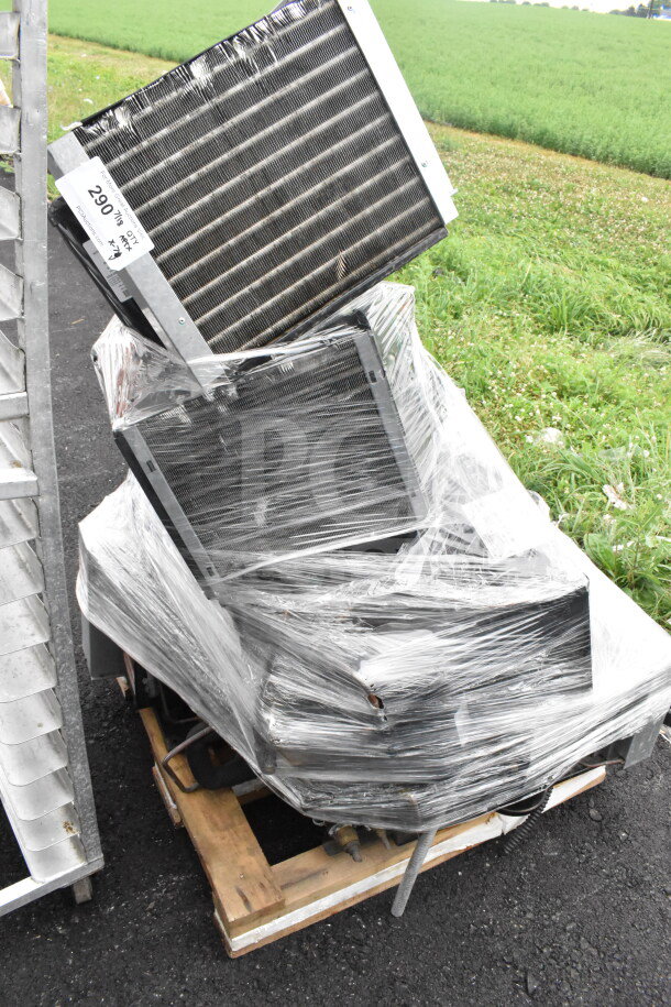 Seven various compressors, including Copeland, wrapped in plastic on a wooden pallet. Visible tag marked "290" indicating lot number.