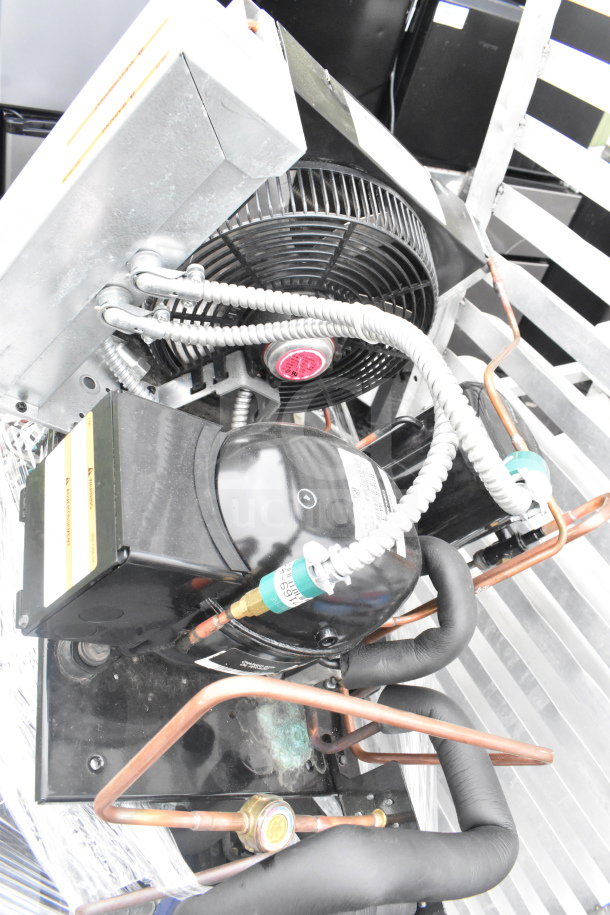 Seven various compressors, including Copeland, showing coiled tubing. Auction lot offers 7 times your bid. Good condition.