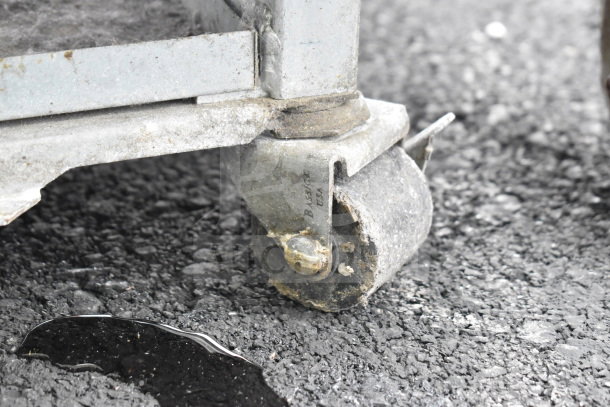 Close-up of a caster wheel on a KARLOS 200 UL Commercial Merchandiser, showing signs of wear.