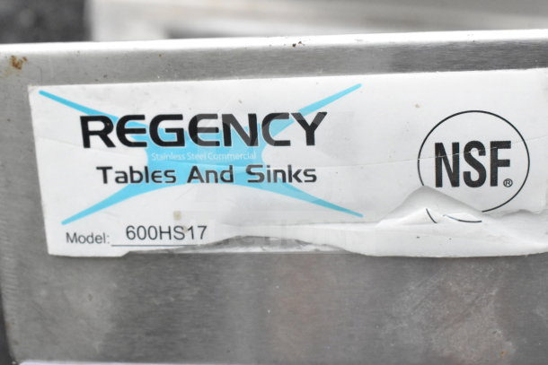 Regency single bay wall mount sink 600HS17, stainless steel, NSF certified, includes label with model details.