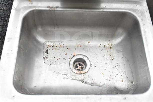 Regency 600HS17 single bay wall mount sink, stainless steel, visible wear and debris, ideal for commercial use.
