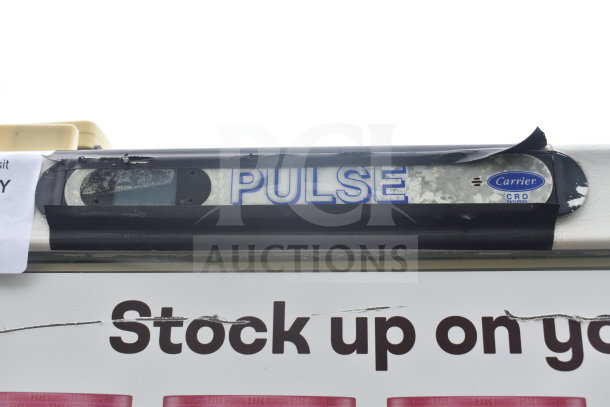 Carrier ULG50BCP-5 commercial 2-door reach-in freezer merchandiser. "Pulse" signage and Carrier logo visible.