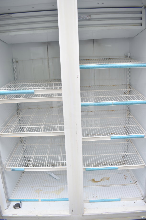 Carrier ULG50BCP-5 commercial 2-door reach-in freezer merchandiser, white, with multiple shelves, 115/208-230V, 1 phase. Visible wear.
