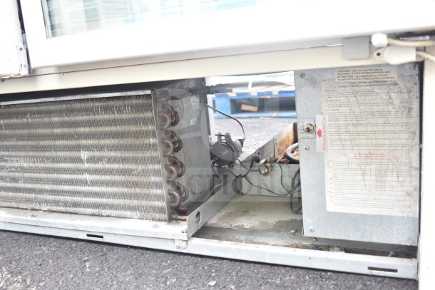 Carrier ULG50BCP-5 Commercial 2 Door Reach In Freezer, detailed view of compressor and power switch.