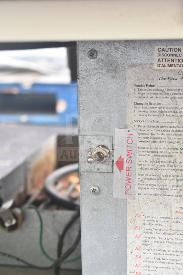 Carrier ULG50BCP-5 commercial freezer power switch and instructions panel with caution label visible.