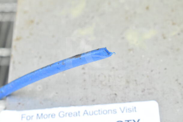 Discarded blue insulation piece on a table, unrelated to the auction item Curtis D60GT12A000 Coffee Machine.