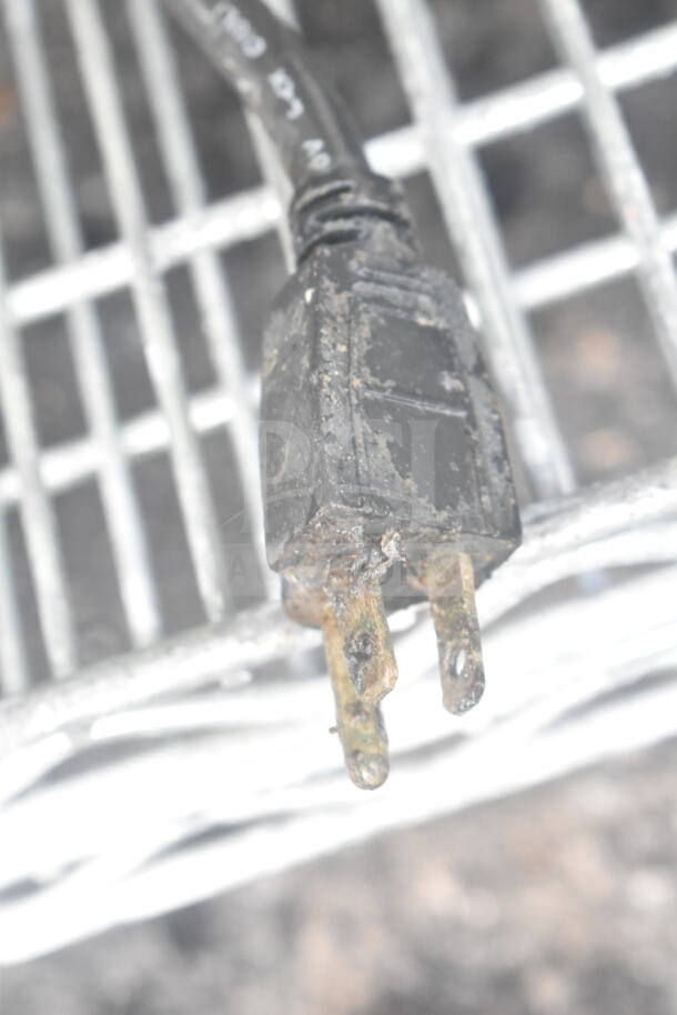 Moldy, corroded electrical plug of Curtis D60GT12A000 coffee machine, indicating poor condition.