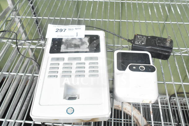 Safescan TA-8025 fingerprint clock in system, moderate wear, keypad and screen visible, includes power adapter.