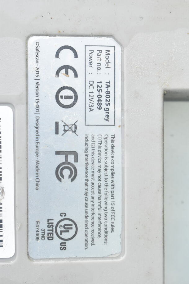 Safescan TA-8025 Fingerprint Clock In System with visible label indicating model TA-8025 grey, part no. 125-0489, power DC 12V/3A.