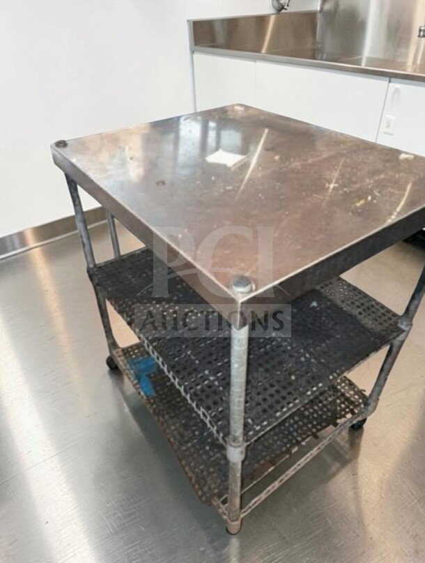 Stainless steel commercial work table, 34" x 30" x 26", with wire undershelf, suitable for restaurant use, in good condition.