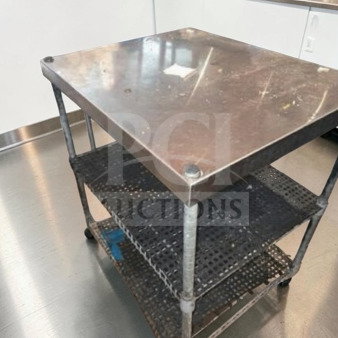 Stainless steel commercial work table, 34" x 30" x 26", with wire undershelf, suitable for restaurant use, in good condition.
