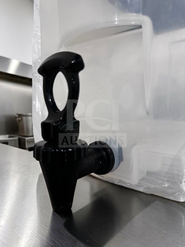 Plastic cold juice dispenser with spigot in like-new condition, ready for use. Unbranded model MIS-S-DISP-1227, countertop compatible.