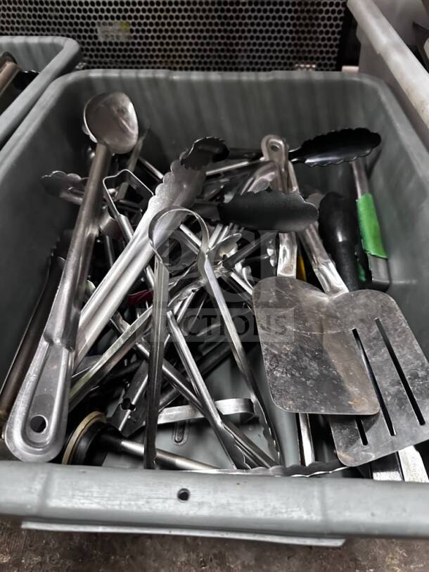 Mixed Commercial Kitchen Utensil Lot in bins, featuring tongs, spatulas, ladles; well-maintained, ready for restaurant use.