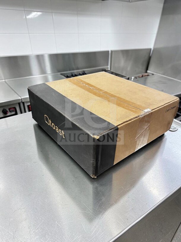 Brand new Toast Cash Drawer in box, model TOA-S-CASH-1239, 16" commercial black POS drawer, sealed packaging.