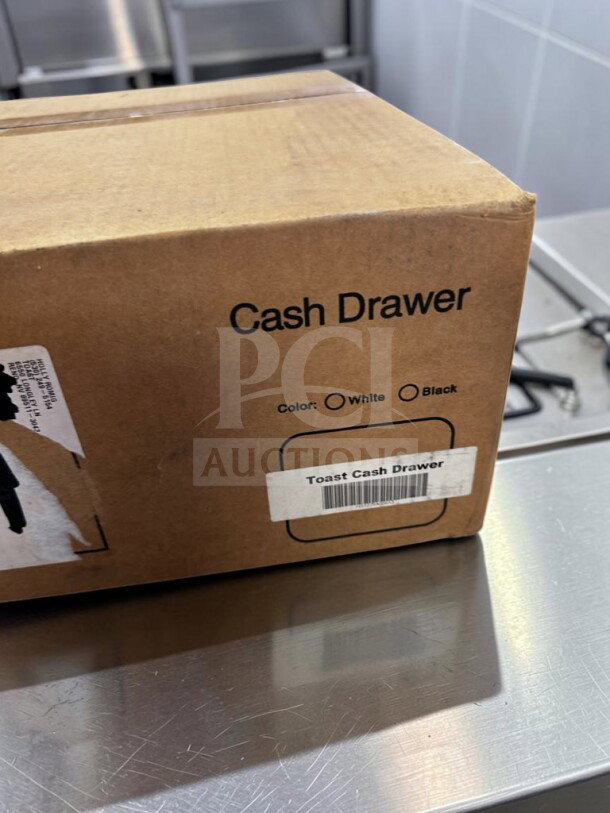 Brand new Toast Cash Drawer in box, black color, 16" size, model TOA-S-CASH-1239, ideal for POS systems.