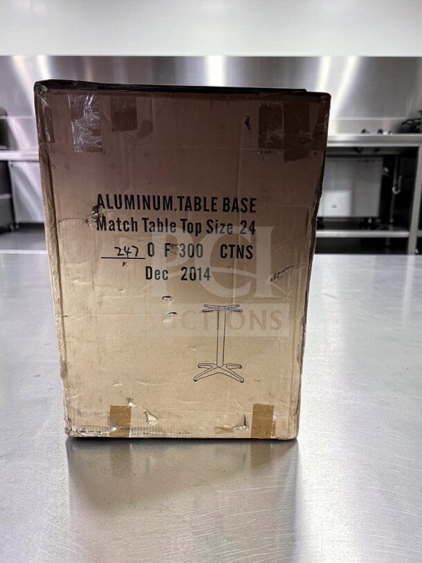 New aluminum restaurant table base in box, fits 24" top, commercial use, generic model, markings show Dec 2014 manufacturing date.