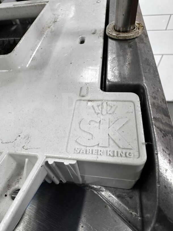 Prince Castle 980-000-00 Saber King manual slicer, white, NSF certified, corner view showing "SK Saber King" branding.