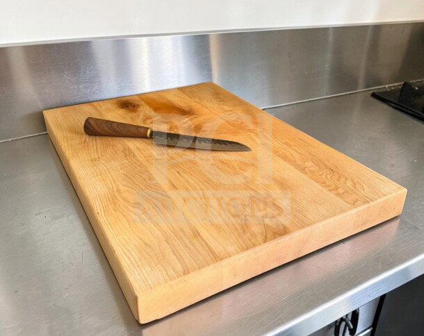 Large maple butcher block cutting board, approx. 24" x 18", with non-slip feet, in good condition, ideal for restaurant use.