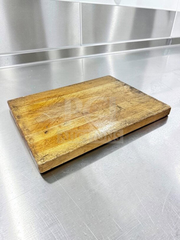 Large maple butcher block cutting board, 24" x 18". Shows light wear, ideal for restaurant use. Non-slip feet included.