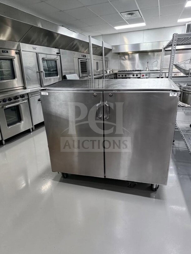 Stainless steel storage cabinet, 48" wide, dual locking doors, heavy-duty worktop, excellent condition, ready for use.