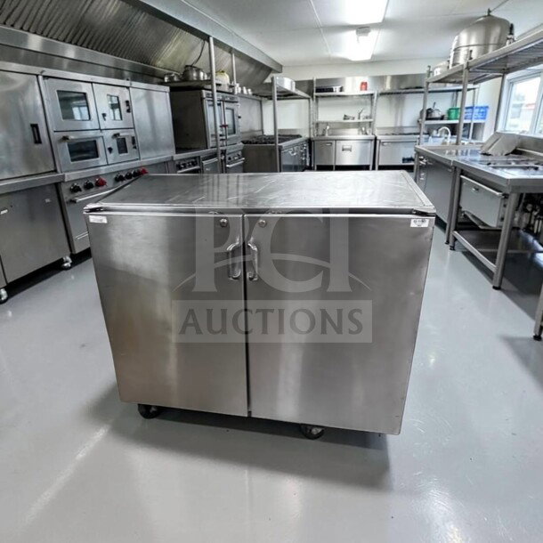 Commercial stainless steel storage cabinet, 48" wide, dual locking swing doors, heavy-duty worktop, well-maintained condition.