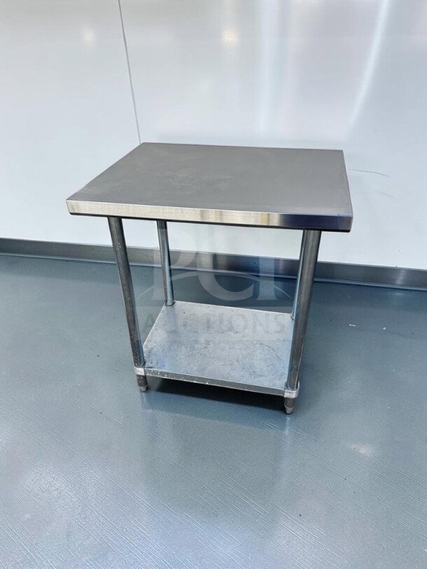 Commercial stainless steel work table, 32" × 24", with adjustable undershelf and casters. First-class condition, fully inspected.