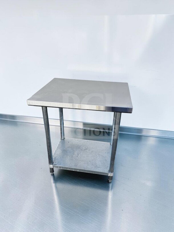 Commercial stainless steel work table, 32" x 24", with adjustable undershelf and casters, in first-class condition.