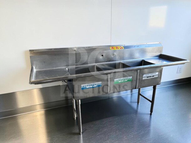 Flawless commercial stainless steel sink with three compartments, dual drainboards, high backsplash, and adjustable legs.