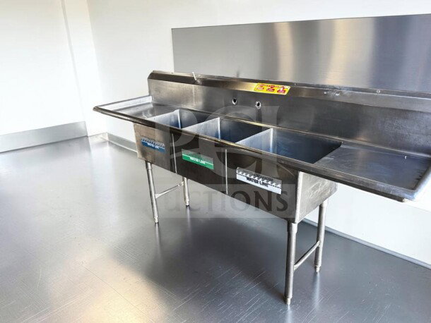 Flawless commercial three-compartment stainless steel sink with dual drainboards, high backsplash, and adjustable legs.