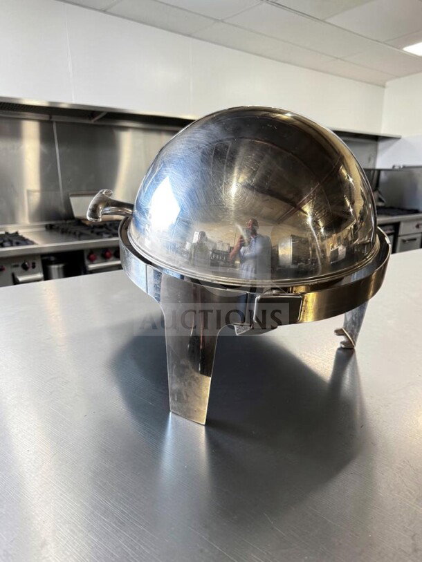 Stainless steel round roll-top chafing dish in premium condition with elevated stand, inspected and ready for use.