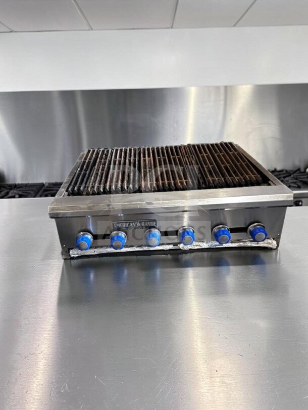 American Range 48" Radiant Gas Charbroiler with six burners, stainless steel, cast-iron grates; excellent condition.