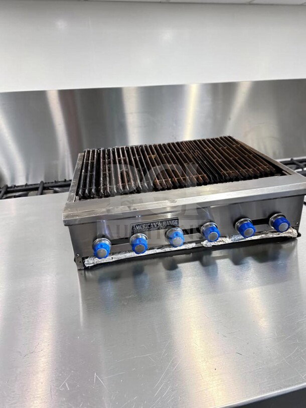 American Range 48" Commercial Radiant Gas Charbroiler, six burners, stainless steel, heavy-duty cast-iron grates, excellent condition.