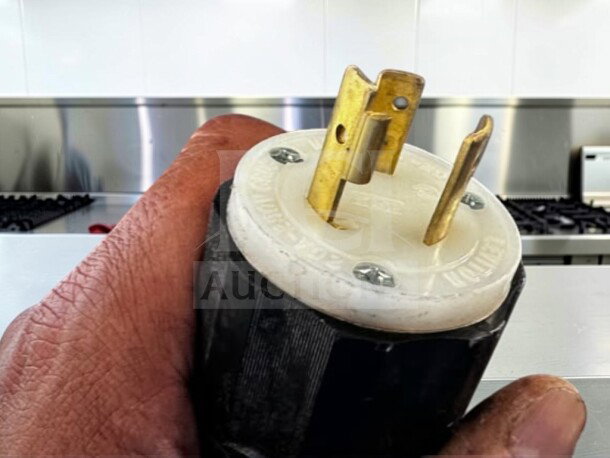 Close-up of a three-pronged electrical plug for the KLüb LT2 Teapresso machine, in excellent condition.