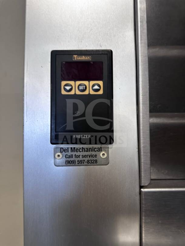 Traulsen G12010 G-Series commercial freezer in flawless condition, solid right-hinged door, 24.2 cu. ft., control panel visible.
