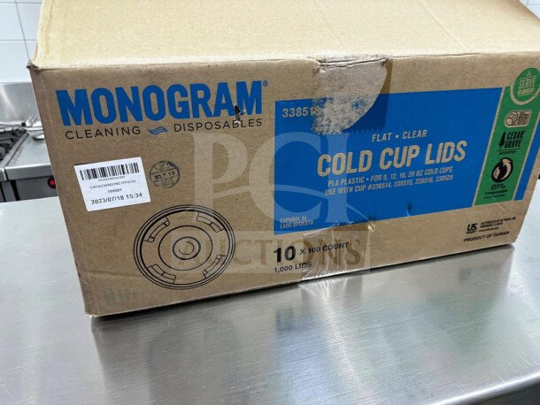 Box of Monogram Serve Good clear PLA cold cup lids, new. Fits 9, 12, 16, 20 oz cups, straw slot, 1,000-count case.
