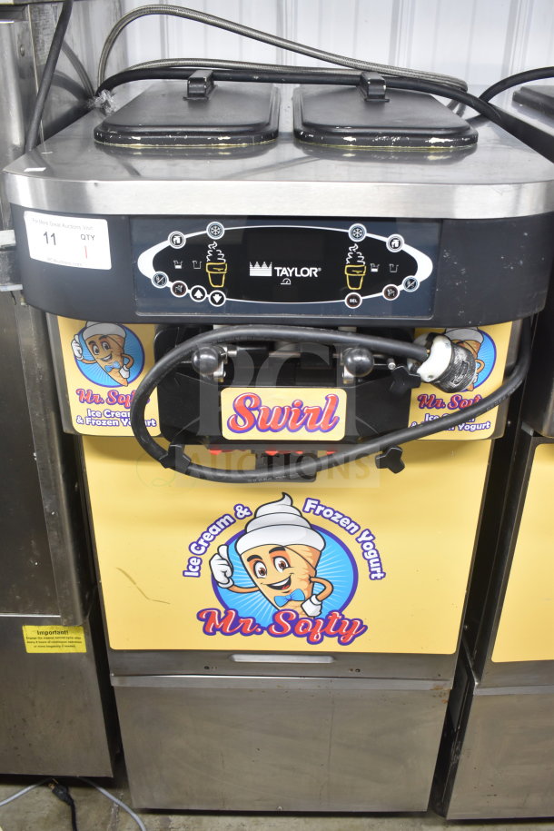 Taylor C723-33 water-cooled soft serve machine, 2 flavors with twist, on casters. 208-230V, 3 phase. Mr. Softee graphics.