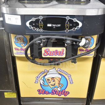 Taylor C723-33 water-cooled soft serve machine, 2 flavors with twist, on casters. 208-230V, 3 phase. Mr. Softee graphics.
